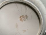 a close up of a silver plate with a picture on it
