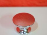 an image of a red knob on a white table