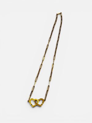 a gold necklace on a white background