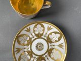 two cups and saucers are sitting on a table