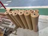 many rolls of brown paper sitting on a cart