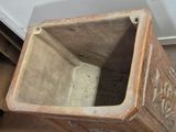 a wooden box with a hole in it on the floor