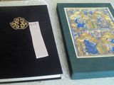 two books sitting on a table with a cross on it