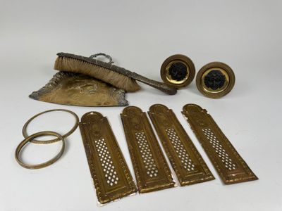 several pieces of brass are sitting on a white surface