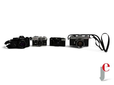 three cameras sitting next to each other on a white surface