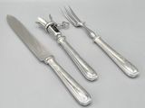 three forks and a knife on a white table