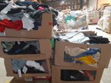 many boxes of clothes stacked on top of each other in a store