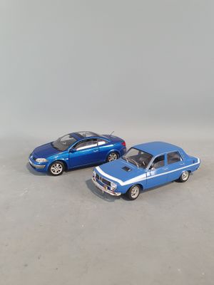 two toy cars sitting next to each other on a table