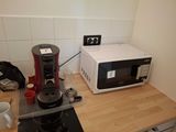 a microwave and a coffee maker on a kitchen counter