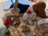 many stuffed animals that are on a bed together