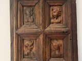 an image of a wooden panel with carved animals on it