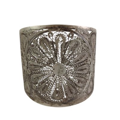 an image of a silver cuff bracelet with a flower design on it