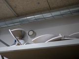 a shelf that has a bunch of dishes and cups on it