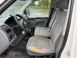the interior of a white truck with the driver ' s seat down