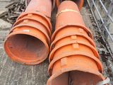 two large orange pipes sitting next to each other on top of a cement floor