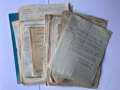 several old papers are stacked on top of each other on a table