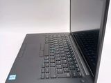a black laptop computer sitting on a white surface