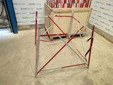 a picture of a construction site with a red and white scaffolding