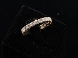a gold ring with diamonds on top of a black velvet box