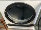 a close up of a washing machine with a door open
