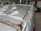 a car that has been painted silver in a garage