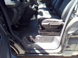the interior of a car with the door open and the seat down