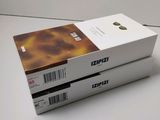 two boxes of kodaki coffee sitting on top of a white table