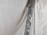 a black umbrella that is wrapped in plastic on a table