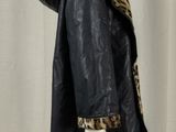 an image of a mannequin wearing a black coat with a leopard print lining