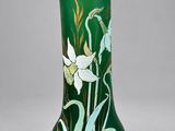 an image of a green vase with flowers painted on it