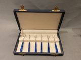 a blue case with four knives in it on a table