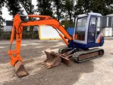 an orange and blue excavator sitting in the dirt
