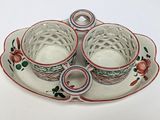 two cups and a saucer sitting on a plate