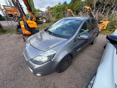 La petite voiture est garée sur le parking, à côté d'autres voitures.