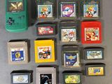 a lot of nintendo games and a gameboy on the table