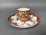a cup and saucer on a saucer on a table