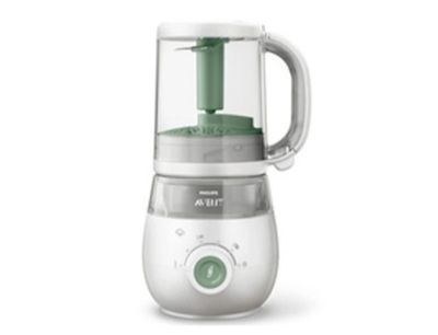 Le robot culinaire pour bébé est blanc et possède une poignée verte.