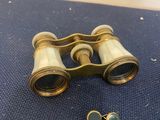 an image of a pair of binoculars sitting on top of a blue surface