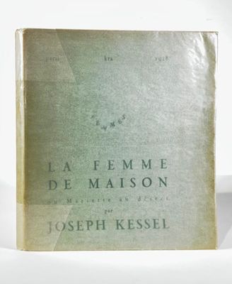 an old book sitting on top of a table next to a white wall