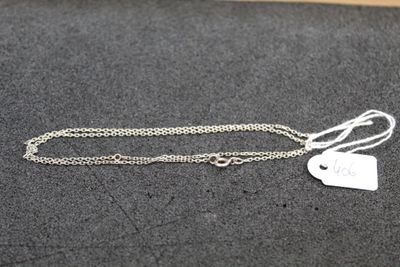 a silver necklace with a heart charm on it