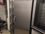 stainless steel refrigerators in a commercial kitchen with tiled flooring