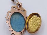 an image of a gold locke with a blue glass in it