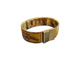 gold plated bracelet with a black and white design on the front