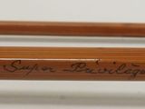 two wooden pencils with writing on them on a white surface