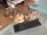 a glass table with a sculpture on it in a living room