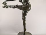 bronze statue of a female dancer on a marble base