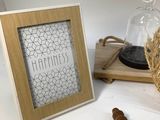 a picture of a cross and a picture frame on a table