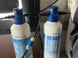 two bottles of water sitting next to each other on a counter