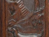 carvings of a dog and a tree on a wooden door
