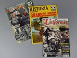 three magazines of different types and sizes on a gray surface